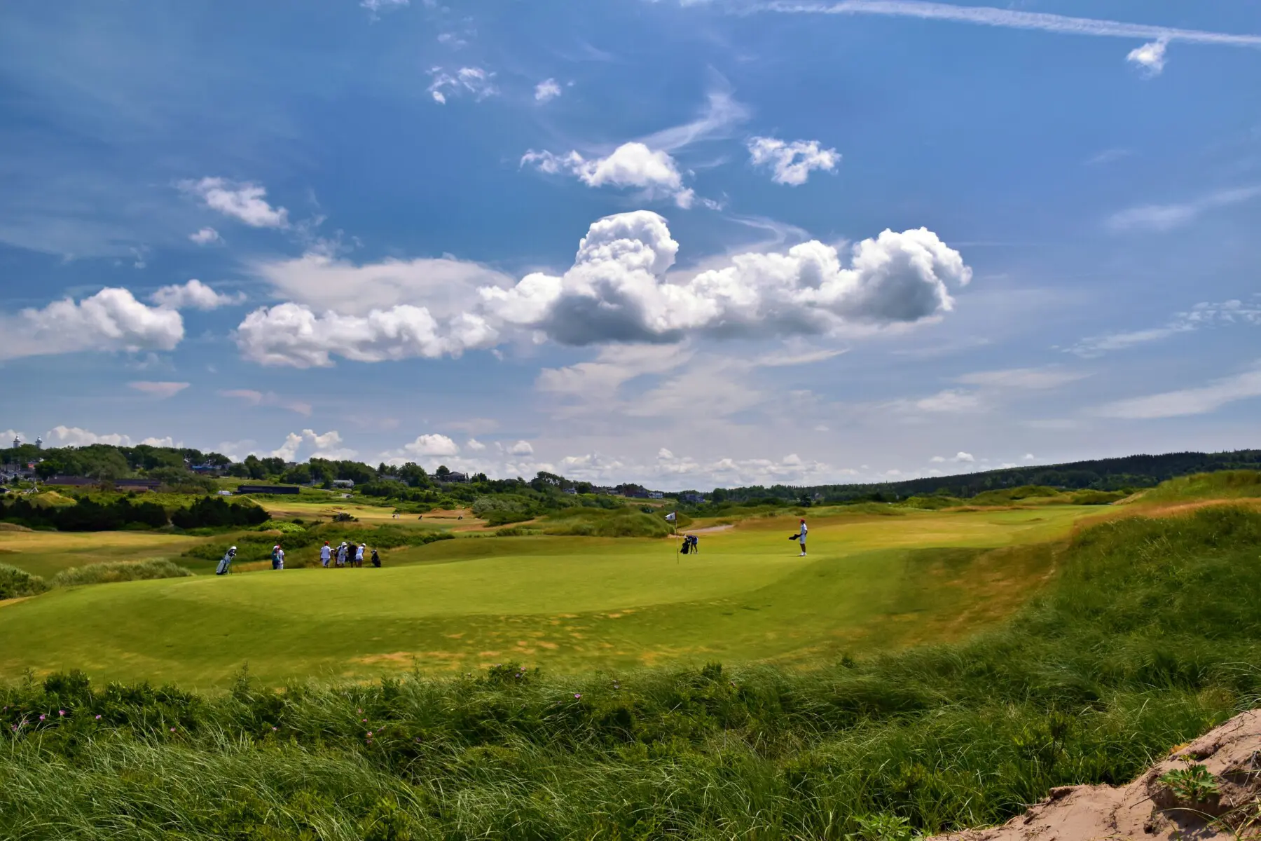 Golfers on the Old Course at St Andrews with dramatic sky